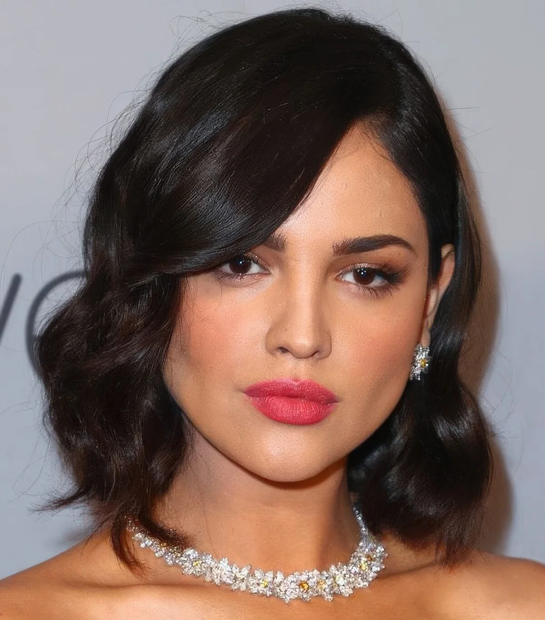 Outgrown black wavy bob with side part and some volume.