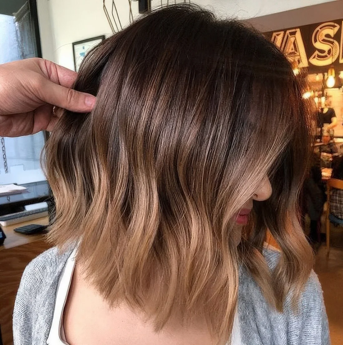 Dark brunette long bob with an ombre effect with light brunette and waves.