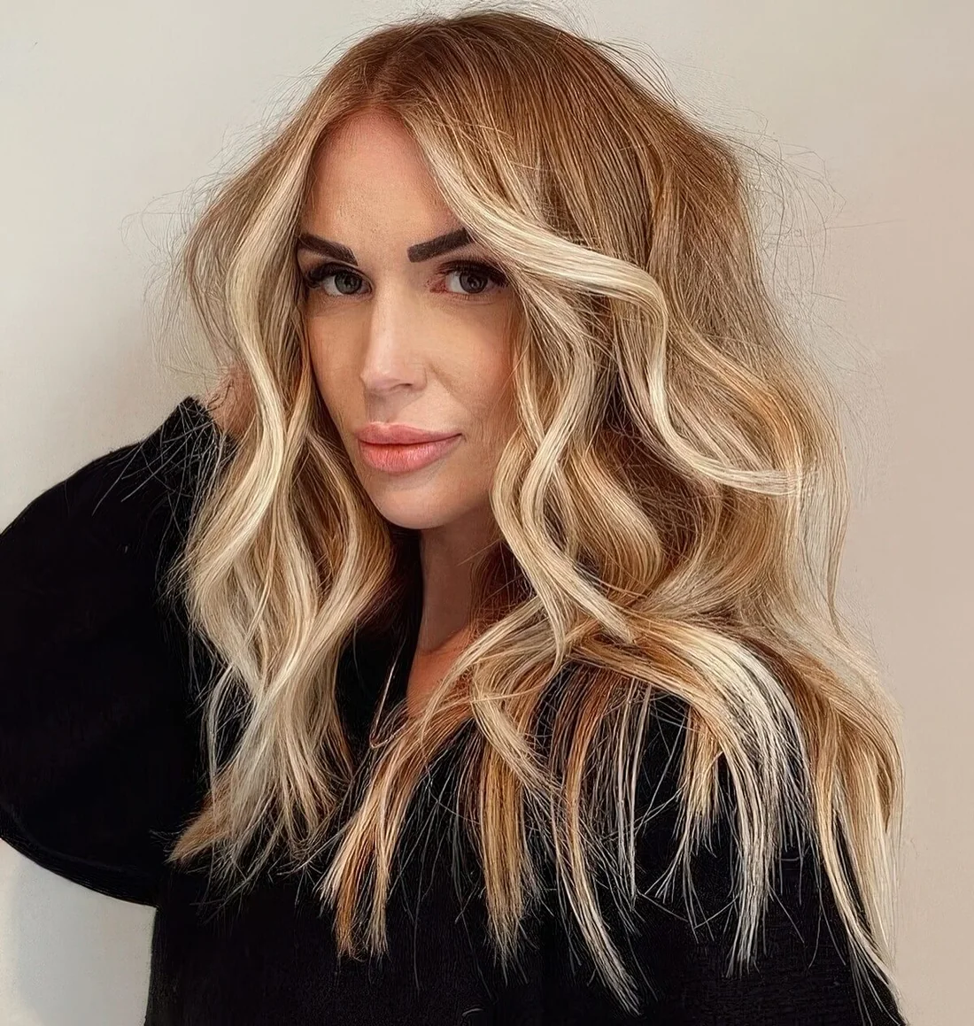 Long bronde hair with gold blonde balayage and waves, with textured hair.