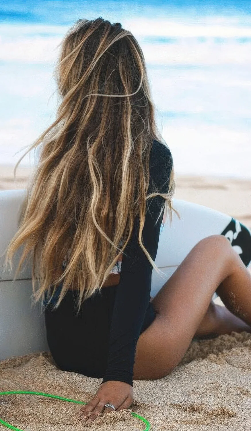 Long dark brown hair with sunkissed beach blonde highlights and a truly beach texture.