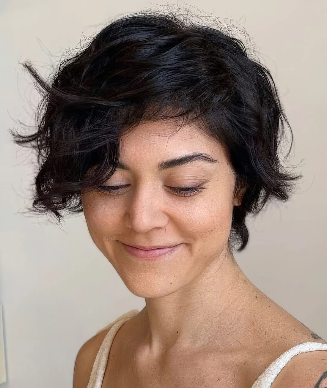 Bixie haircut on black wavy hair and textured ends.