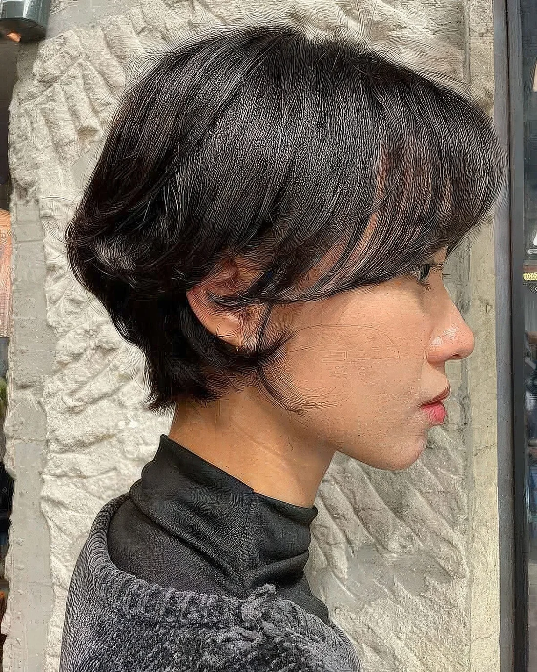 Layered dark brown bixie with face-framing bangs.