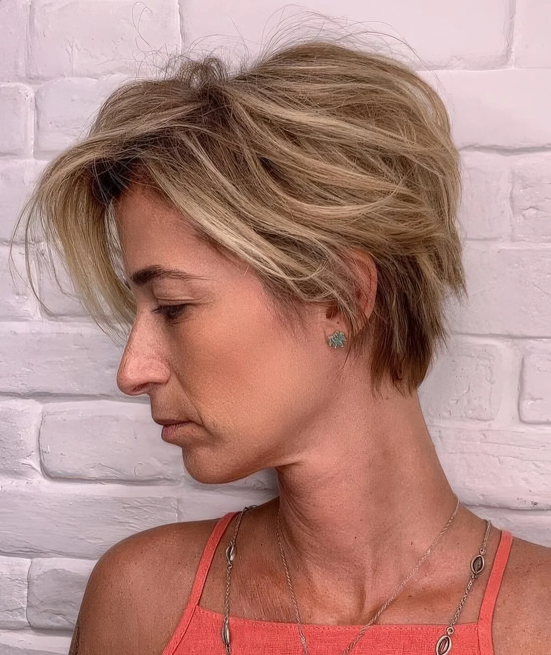 Messy and textural blonde bixie with a messy volume on top.