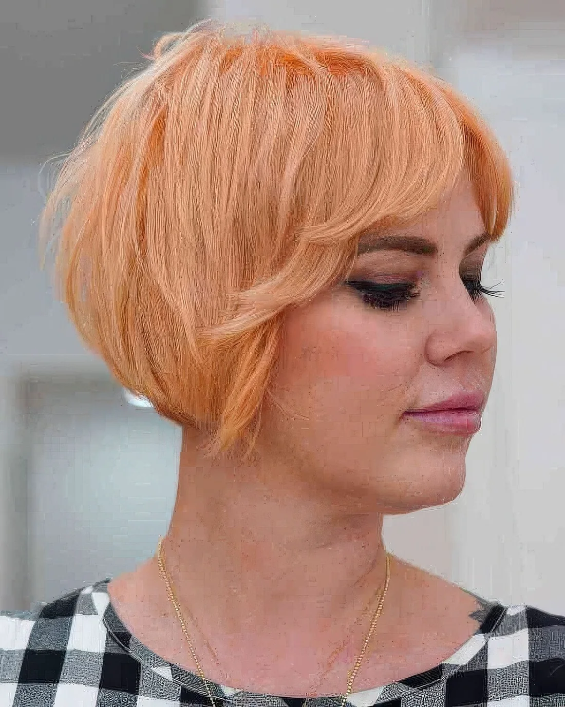 Peach razor cut bixie featuring length on the bottom and texture throughout the top, it's easy to style.