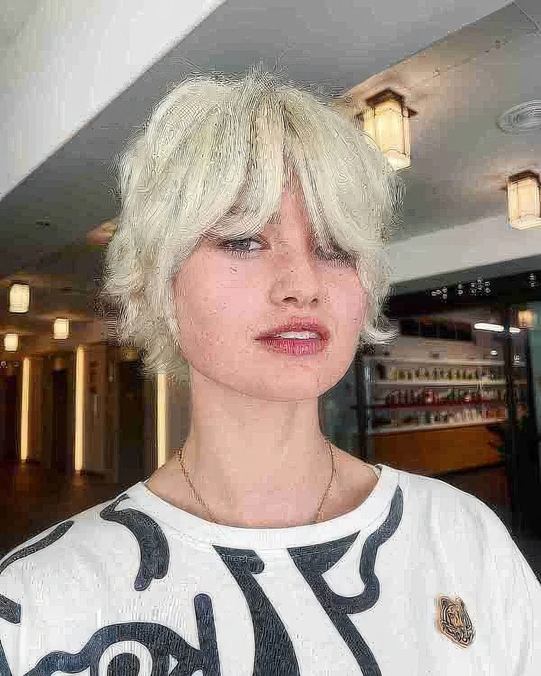 Photo showing shaggy blonde bixie cut, with the hairstyle clearly visible.