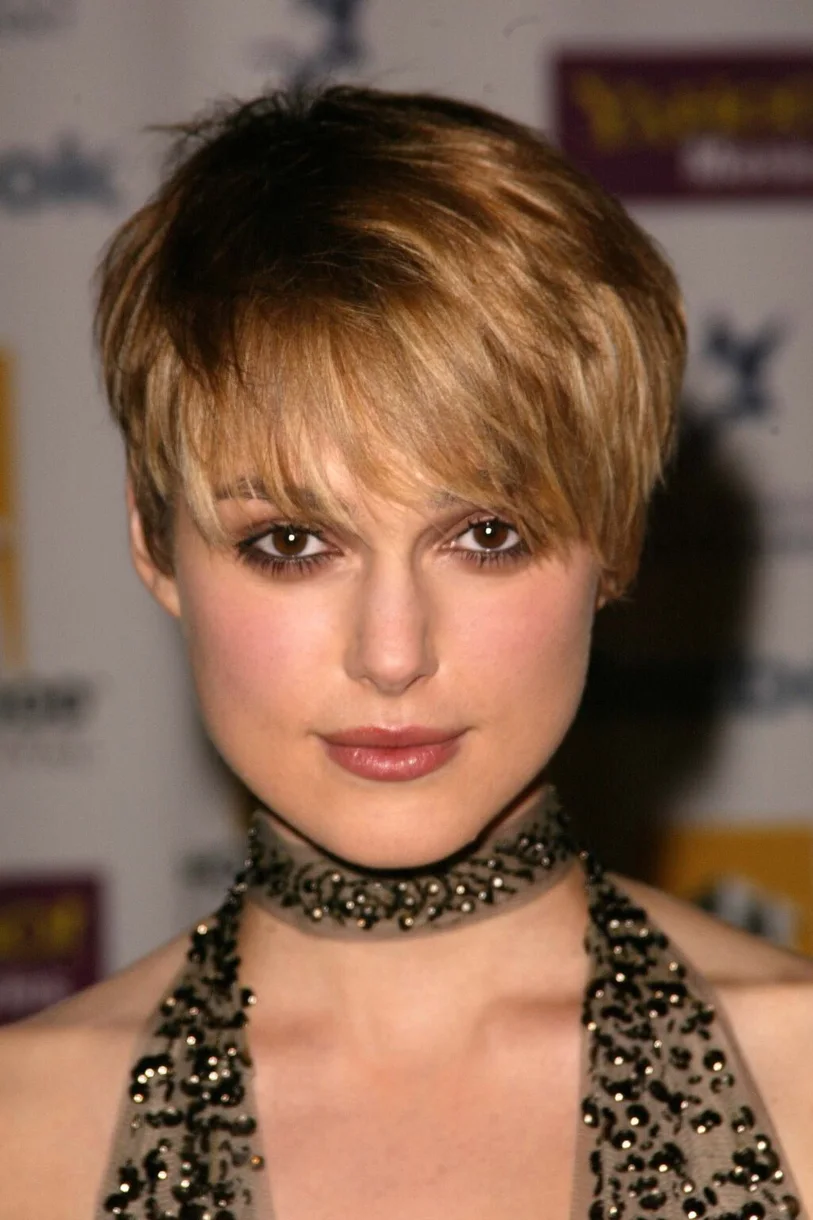 ear straight golden pixie with wispy fringe shown as a bixie haircut idea, featuring textured finish