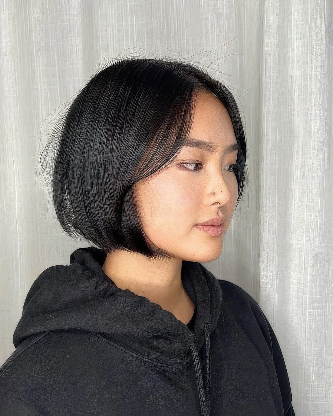 Black blunt chin-length bob with face-framing layers and a sleek finish.