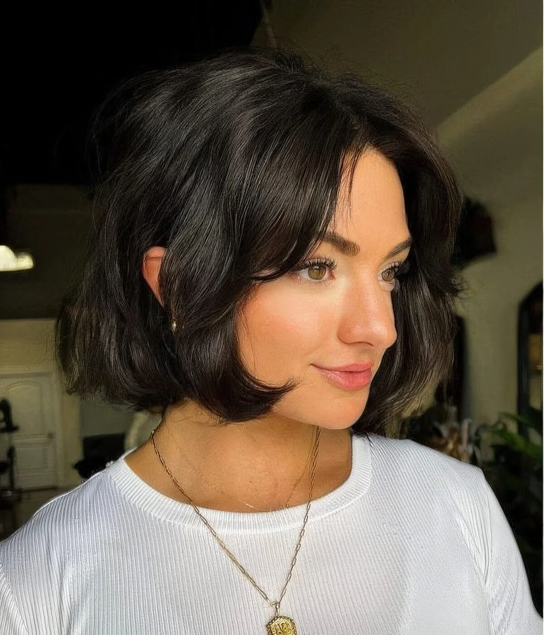 Black chin-length bob with side bangs and waves.