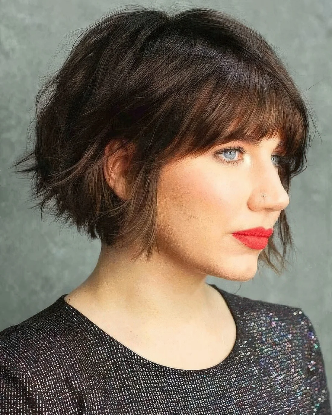 Black jaw-length bob with a shaggy texture and a classic fringe.