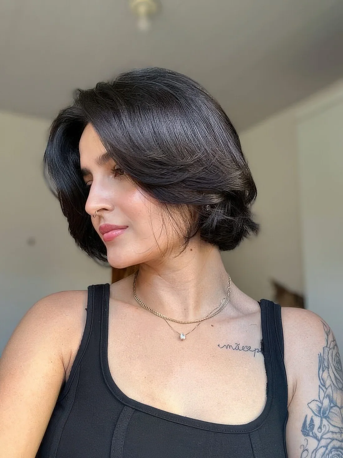 Chin-length black bob with side bangs and curved ends.