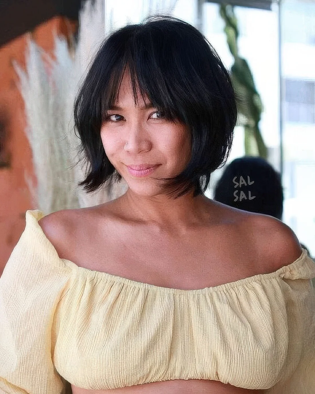 Black jaw-length bob with wispy and bottleneck bangs plus curved ends.