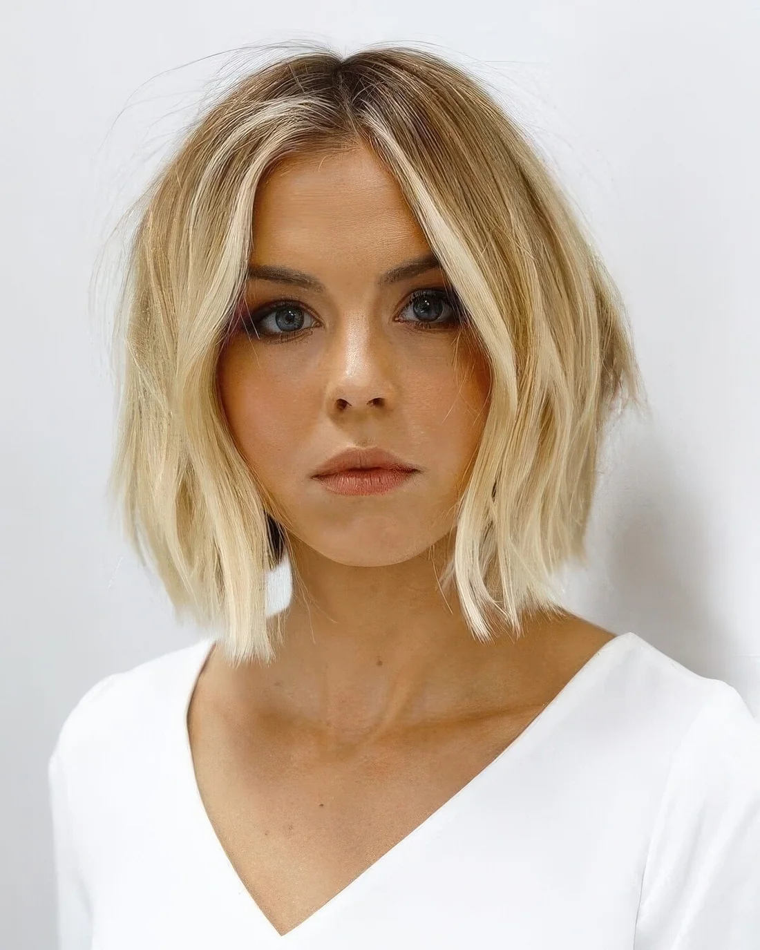 Blonde bob with a warmer shade on top and bleached ombre plus messy waves.