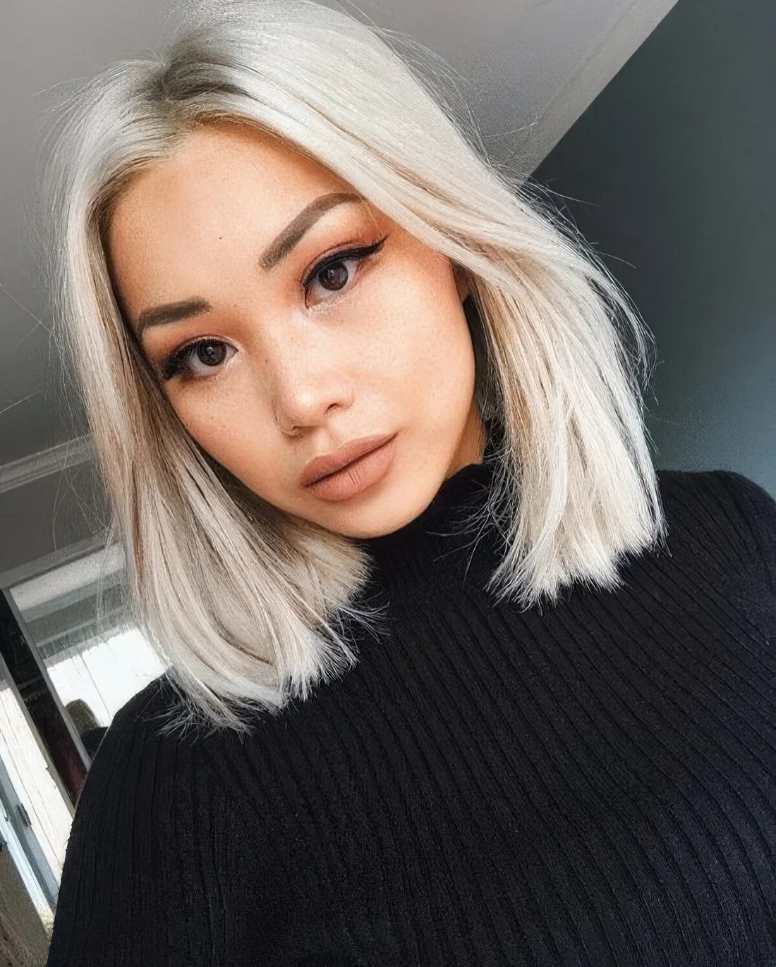 Long icy blonde bob with middle part and a bit of texture.