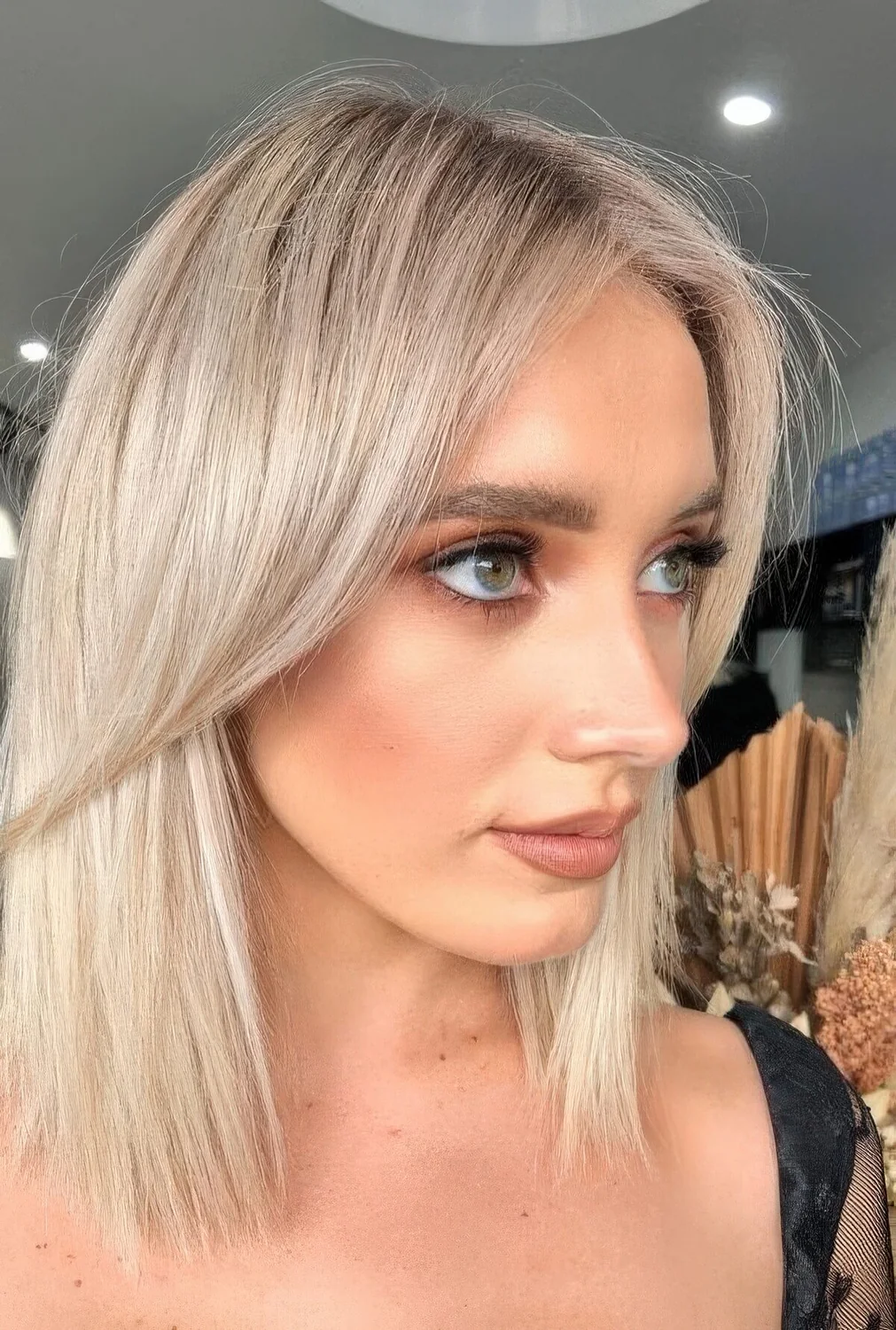 Long platinum bob with curtain bangs.