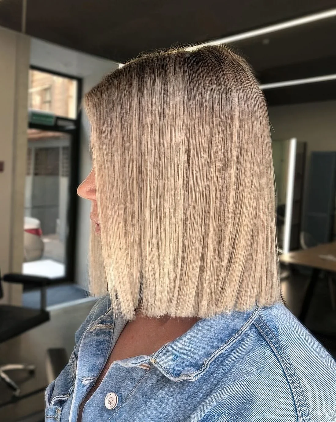 Natural looking long blunt bob with a darker root and straight hair.