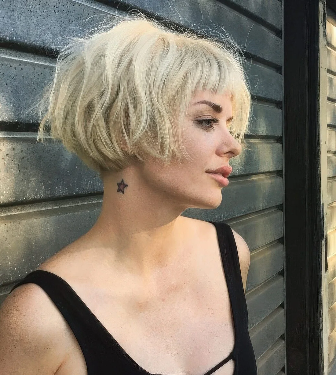 Short blonde messy ear-length bob with a classic fringe and dimension.