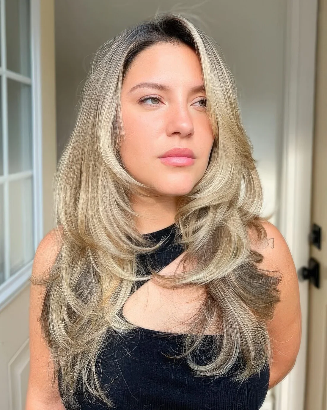 Bronde to blonde long butterfly haircut with wavy ends and a bit of volume.