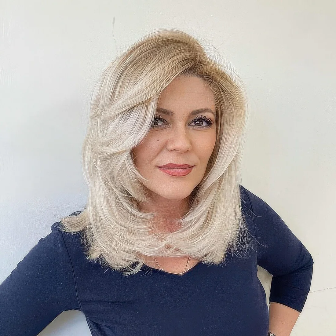 Bleached blonde medium-length butterfly haircut with a lot of volume.