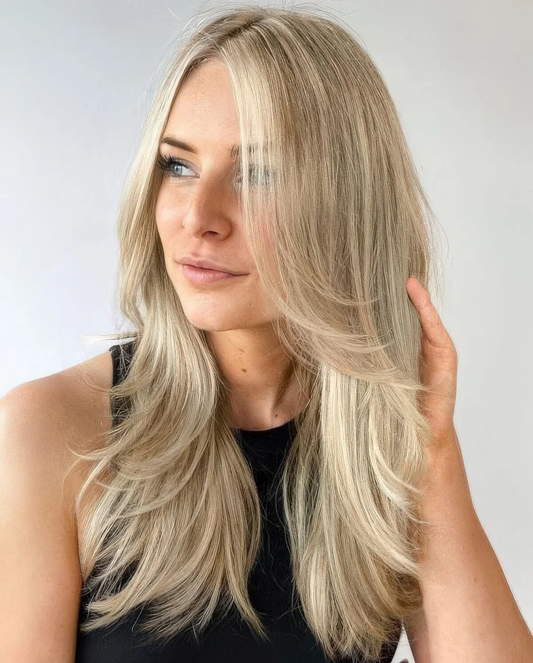 Bright blonde butterfly haircut with curved ends.
