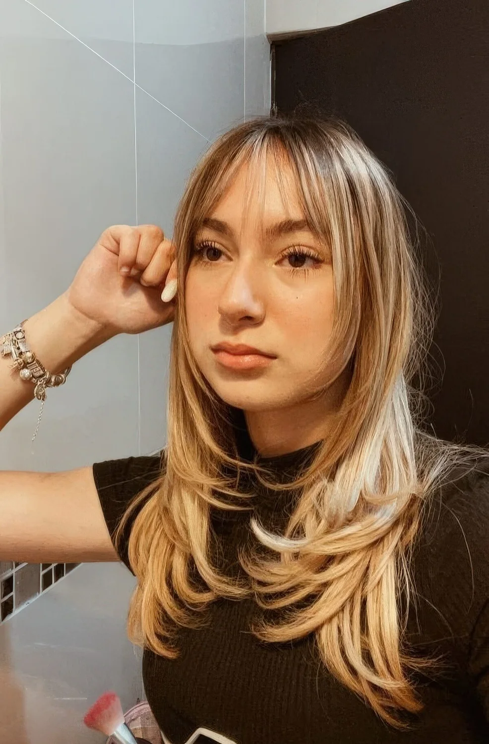 Butterfly haircut with wispy bangs.