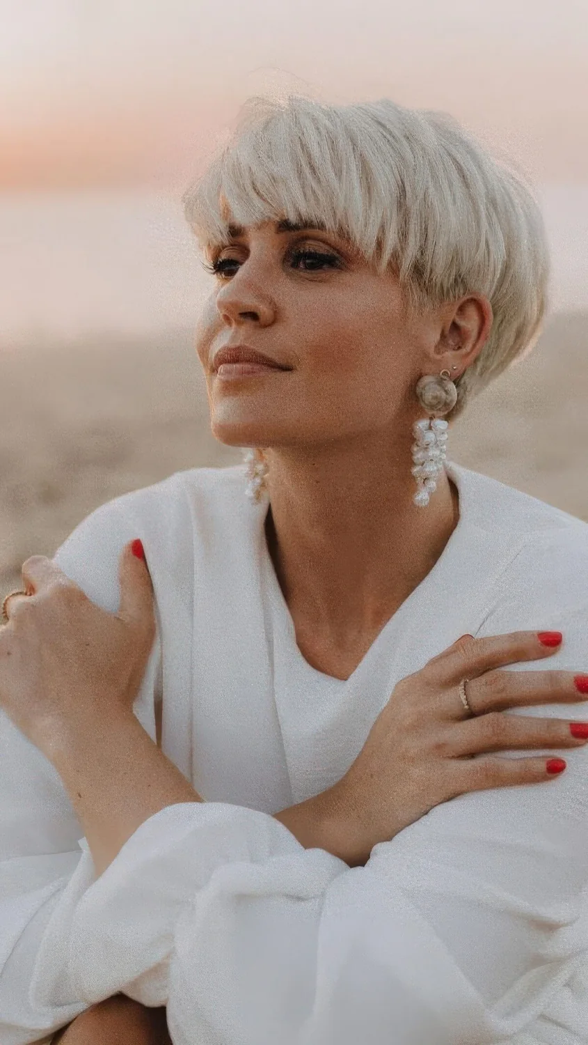 Blonde long pixie to bowl cut with classic fringe done on thick hair.