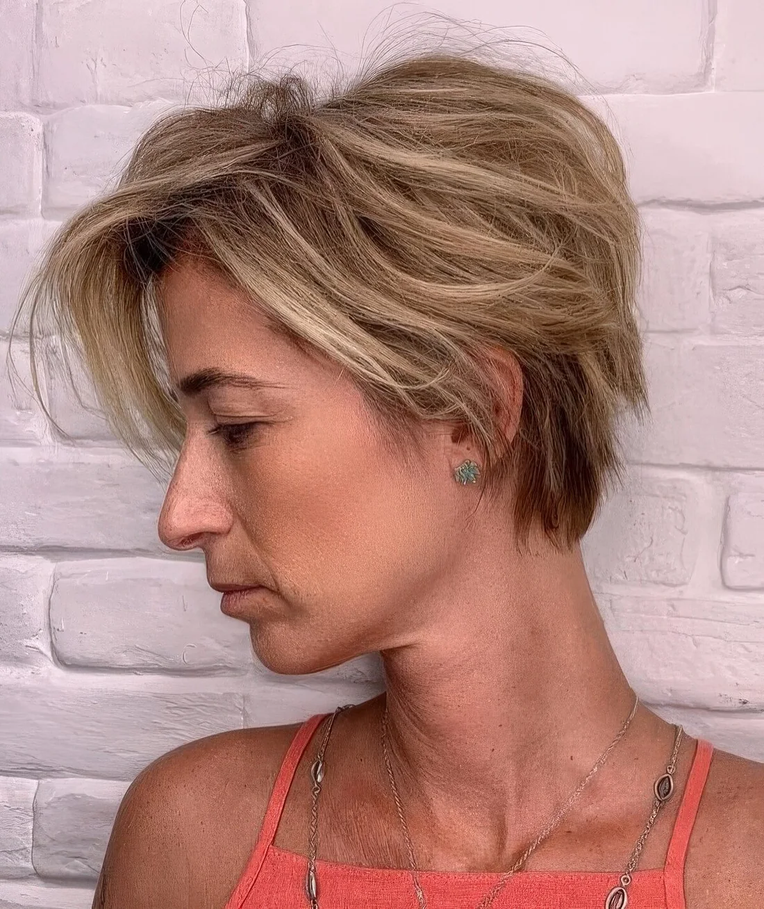 Messy and textural blonde bixie with a messy volume on top.