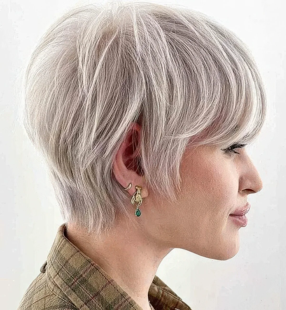 Platinum toned layered long pixie cut requires only a blow dry for a beautiful and stylish look.