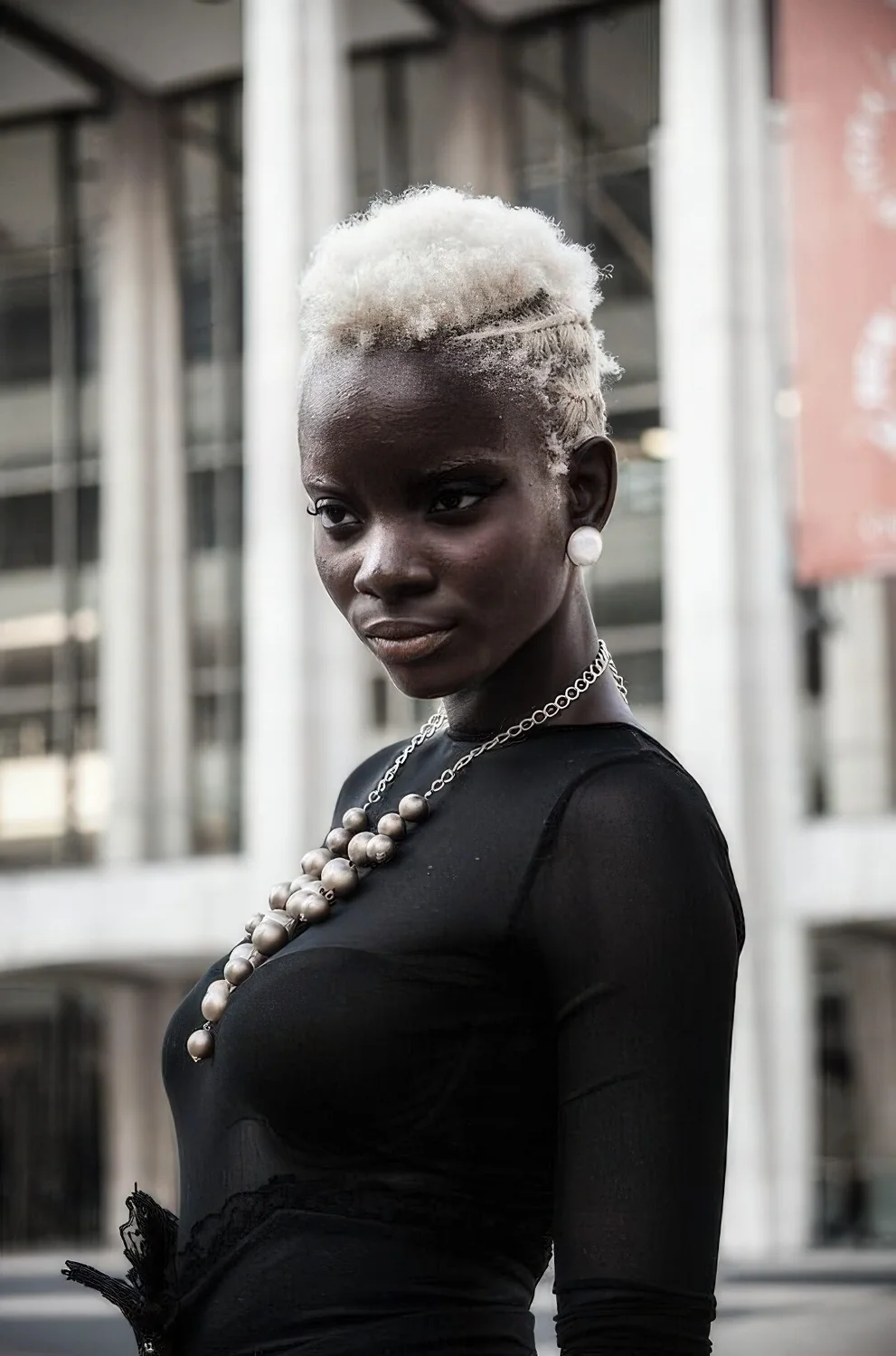 Short icy blonde haircut with curls.