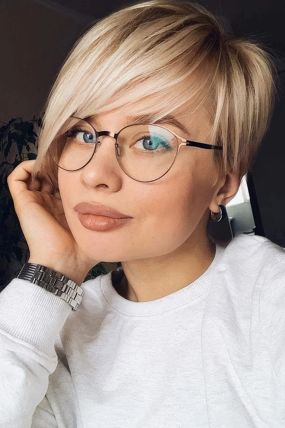 Straight long blonde pixie haircut with side part and volume.