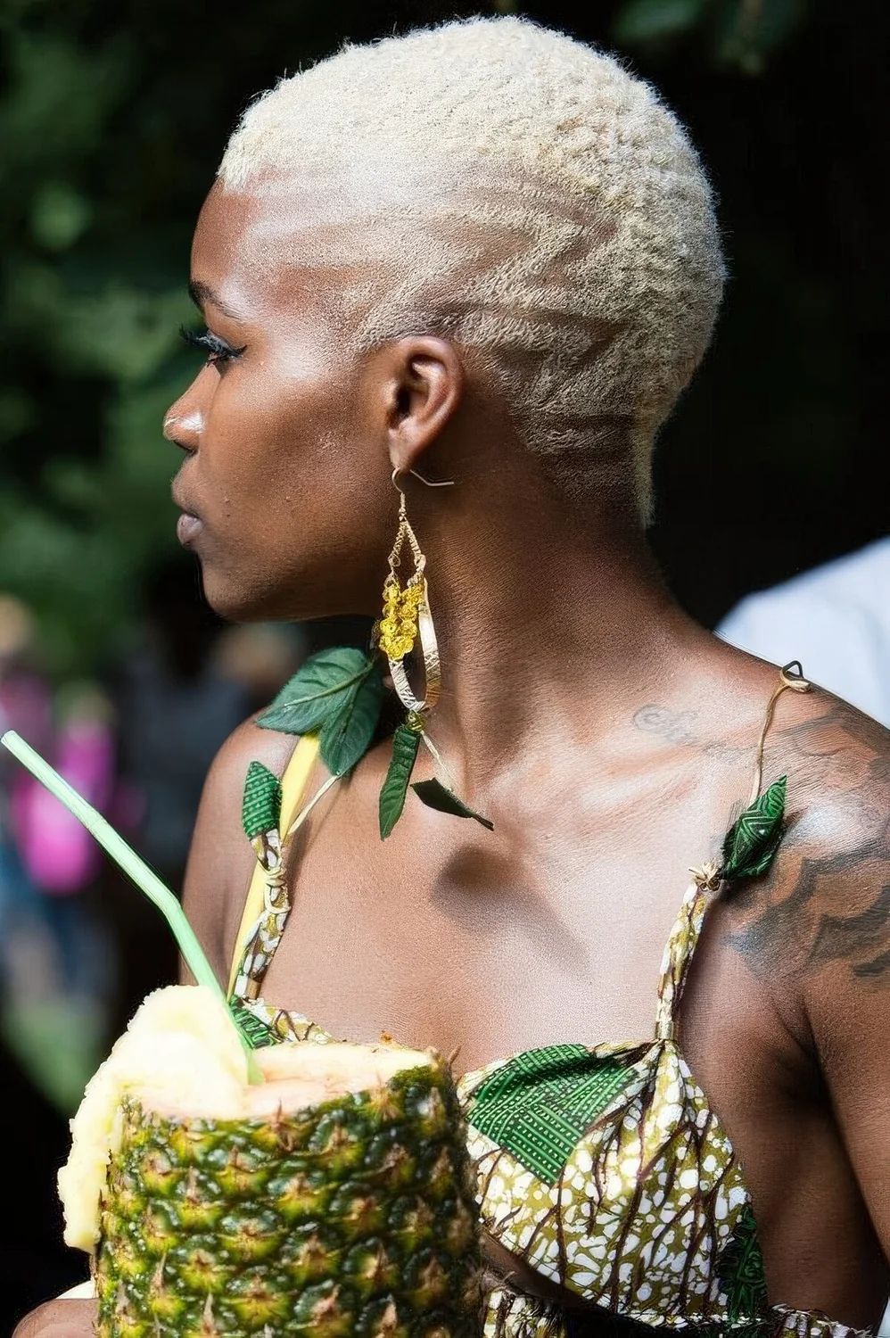 Very short blonde pixie haircut with a geometric touch for an edgy feel.