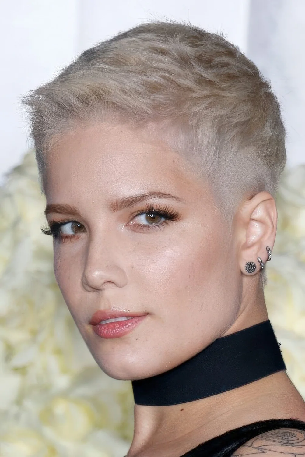 Ash blonde short pixie cut with raised up locks.