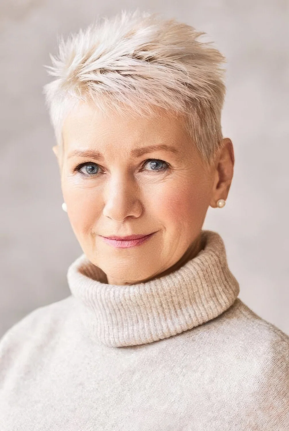 Icy blonde short pixie cut with texture and volume.