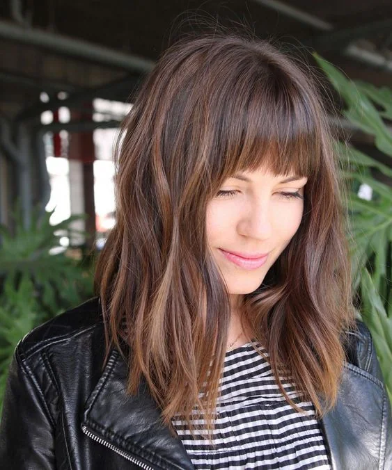 Photo showing bob hairstyle with bangs, with the hairstyle clearly visible.