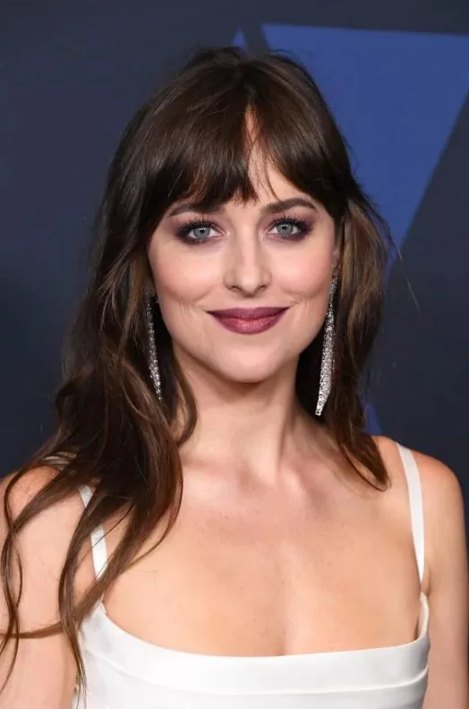 Dakota Johnson's bangs are thick and blunt and soft all at the same time.