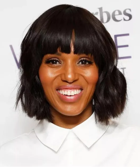 Kerry Washington's straight bangs juxtaposed with a wavy lob perfectly frames her oval face and (killer) bone structure.