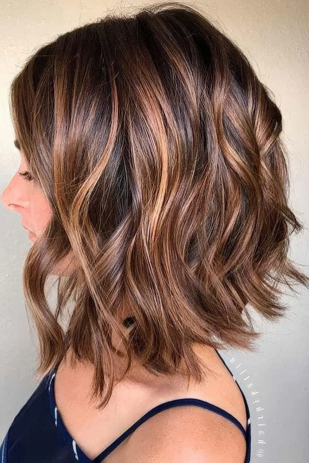 Long bob with layers, caramel balayage and waves.