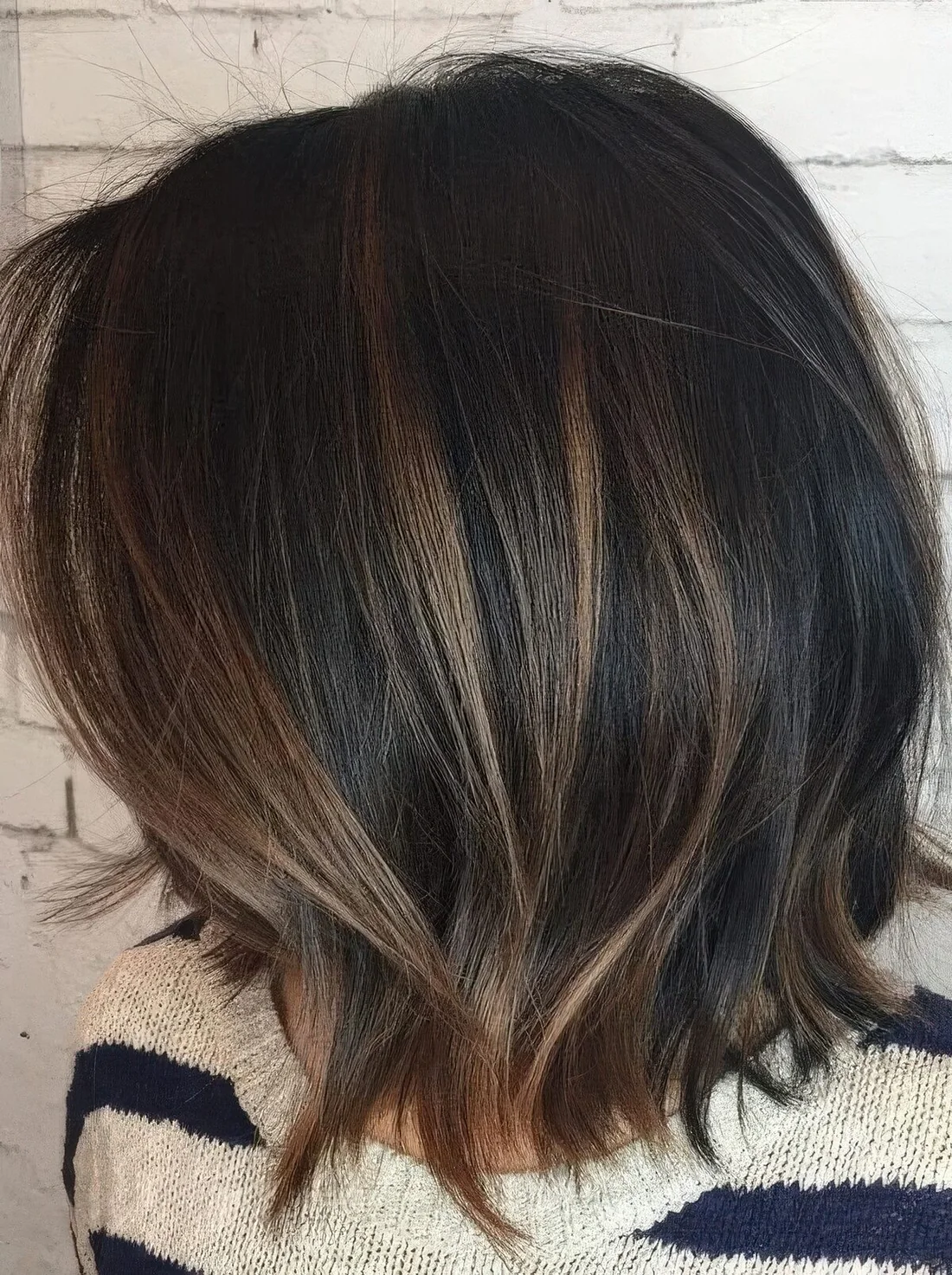 Black bob with caramel balayage and babylights.