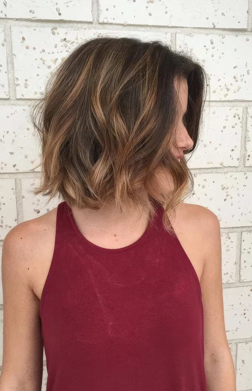 Black bob with caramel balayage and waves.