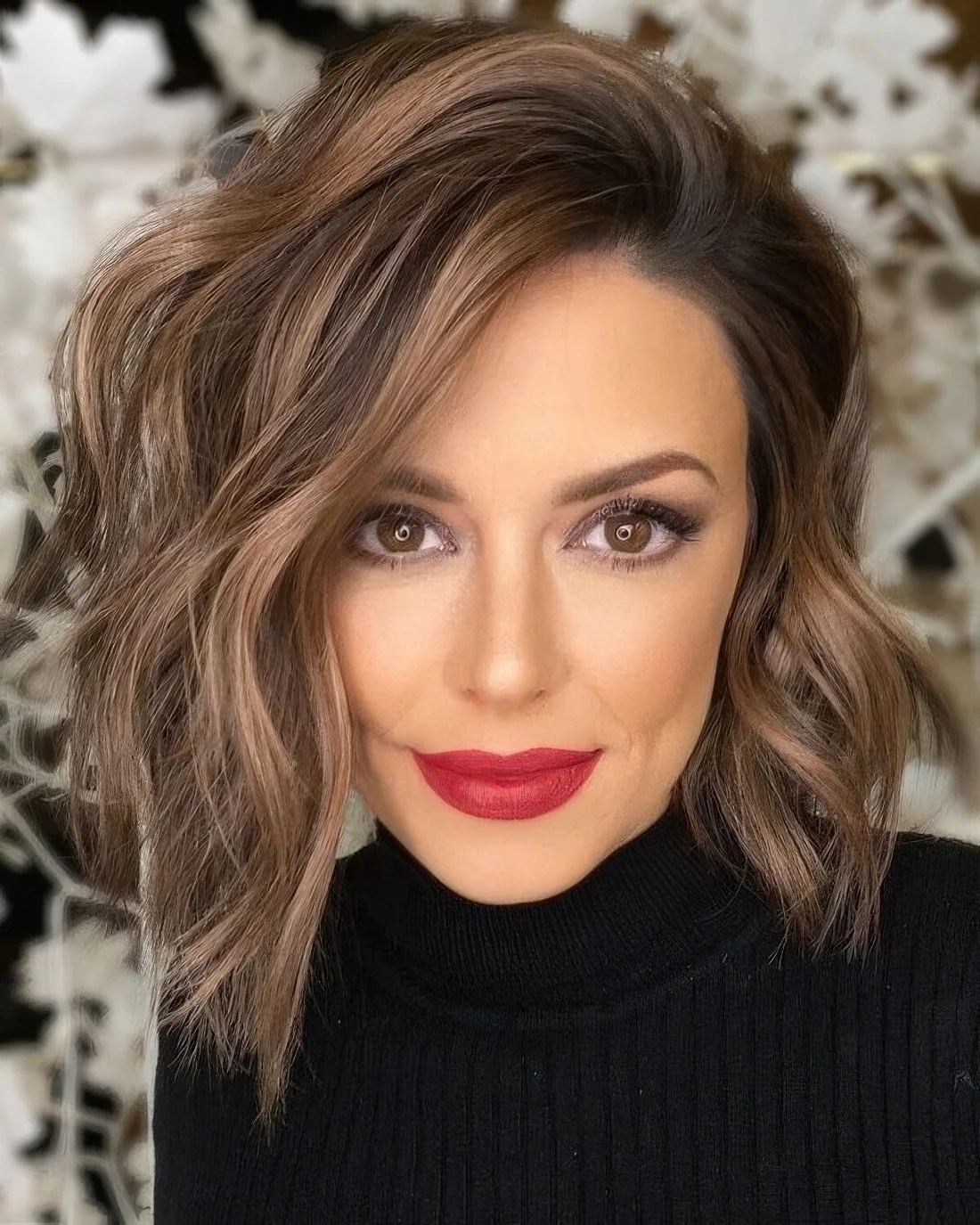 Killer brown layered asymmetrical bob with chestnut balayage and waves.
