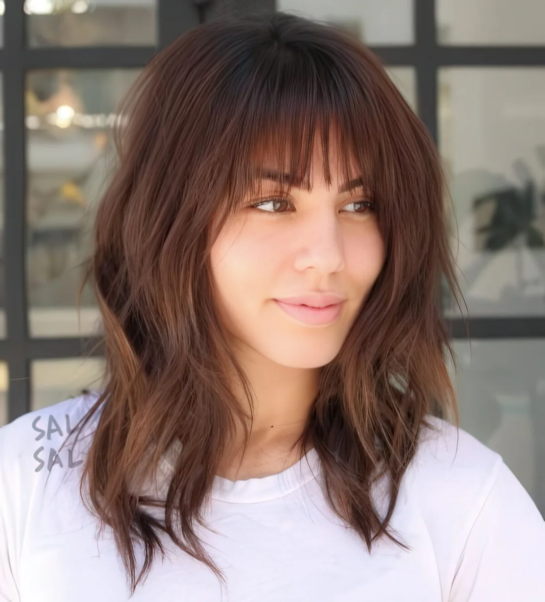 Photo showing long shaggy bob with bangs, with the hairstyle clearly visible.