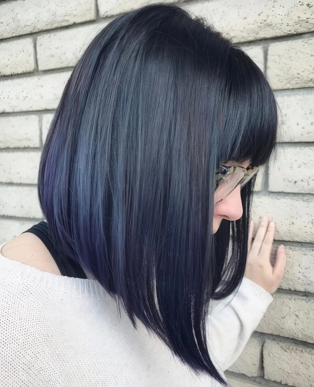 Photo showing angled bob with bangs, with the hairstyle clearly visible.