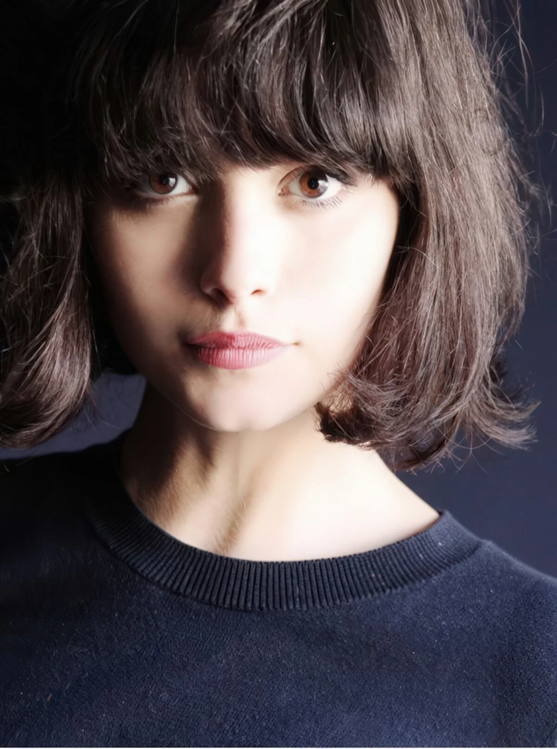 Photo showing short layered bob with long bangs, with the hairstyle clearly visible.