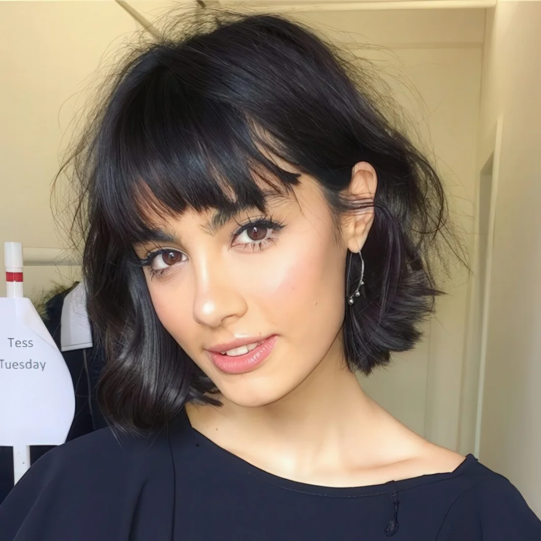 Photo showing short messy bob with bangs, with the hairstyle clearly visible.