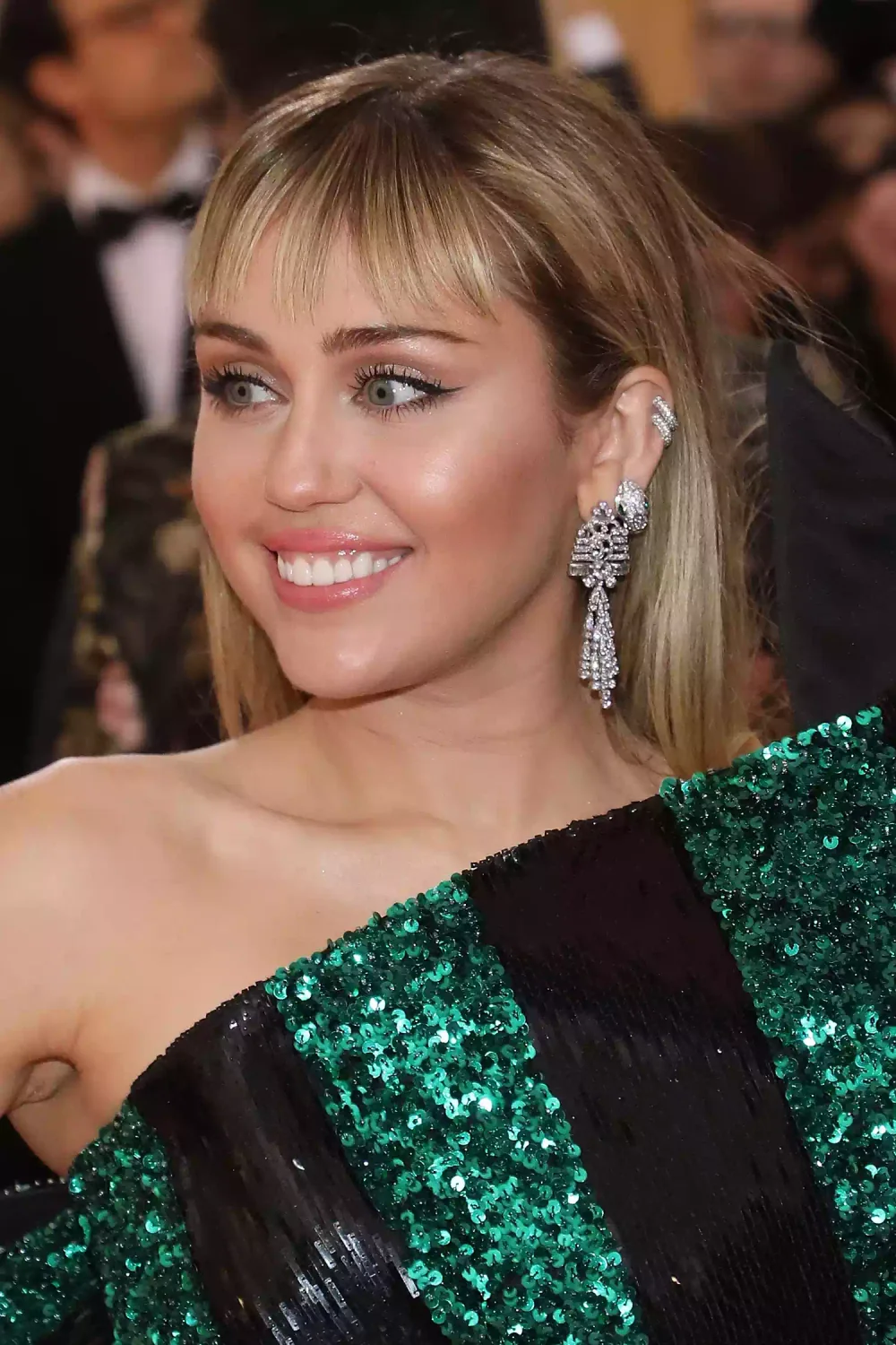 Blonde chin-length bob with long separated bangs.