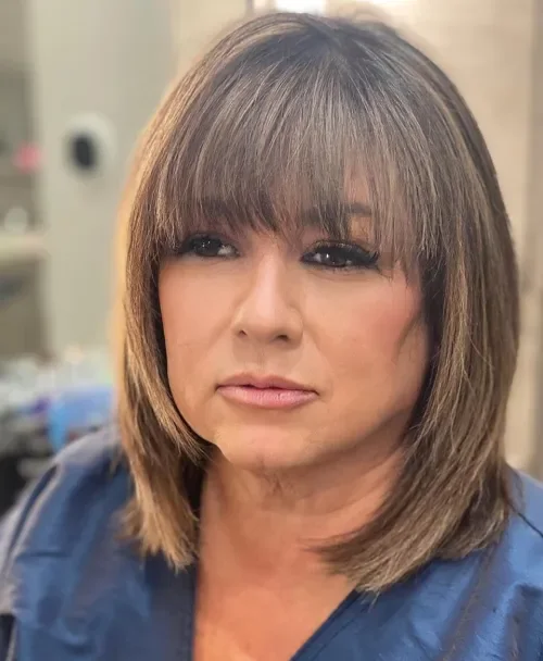 Soft brunette bob with a full fringe and turned under ends.