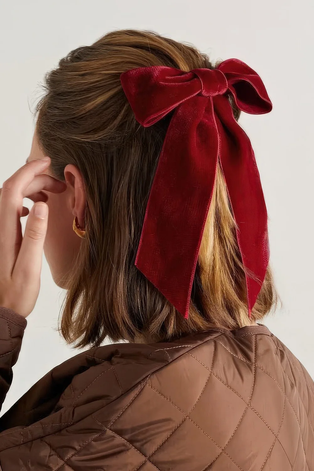 Photo showing red velvet bow, with the hairstyle clearly visible.