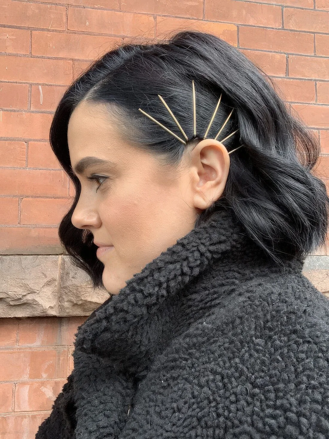 Photo showing simple hair pins, with the hairstyle clearly visible.