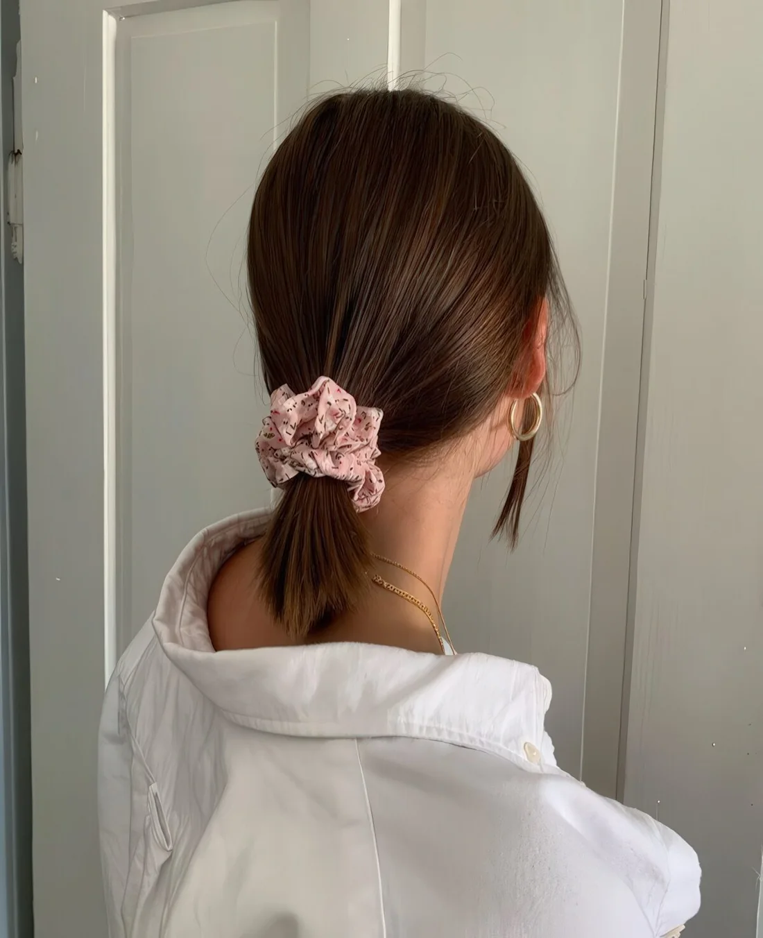Photo showing pink scrunchie, with the hairstyle clearly visible.
