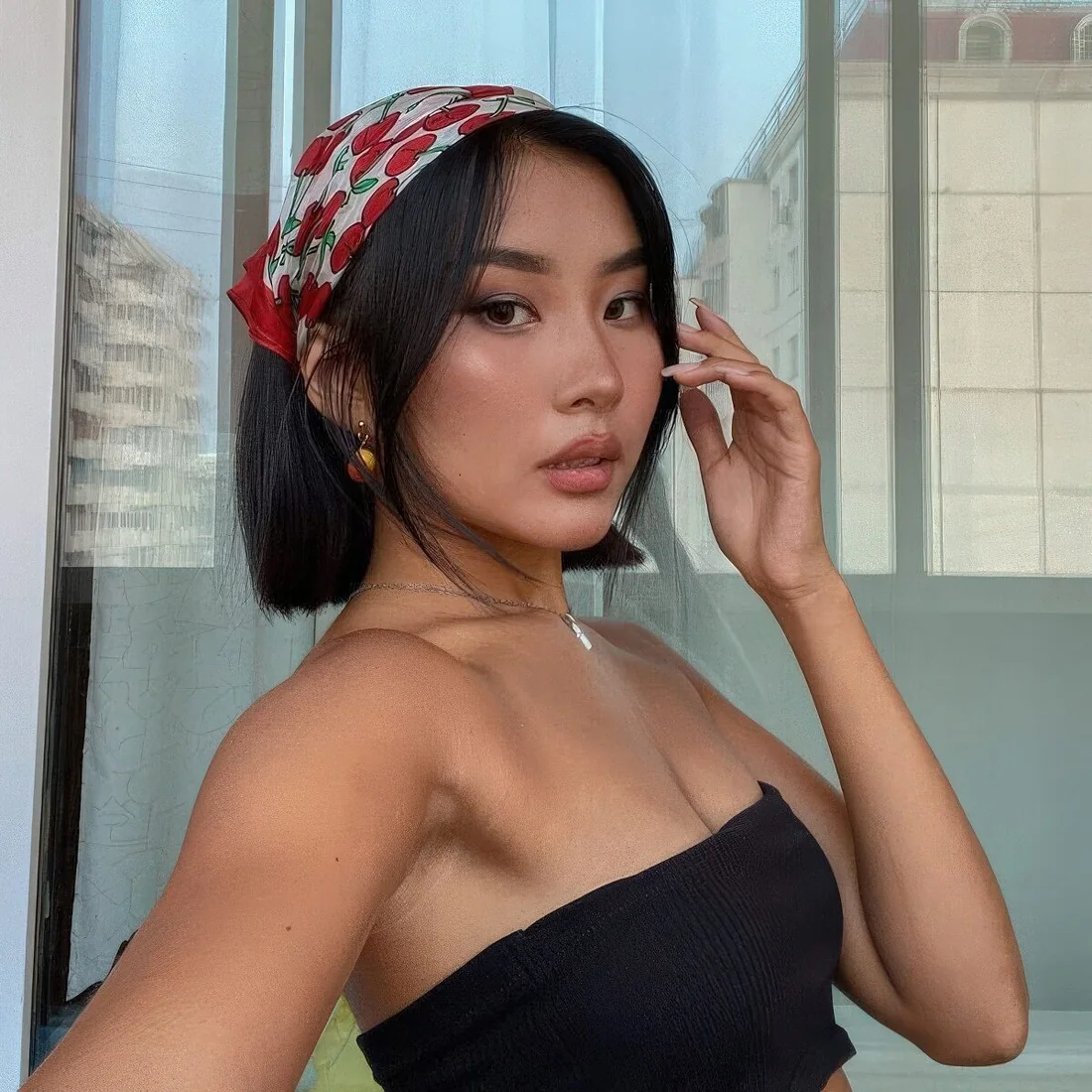 Photo showing bright head scarf, with the hairstyle clearly visible.