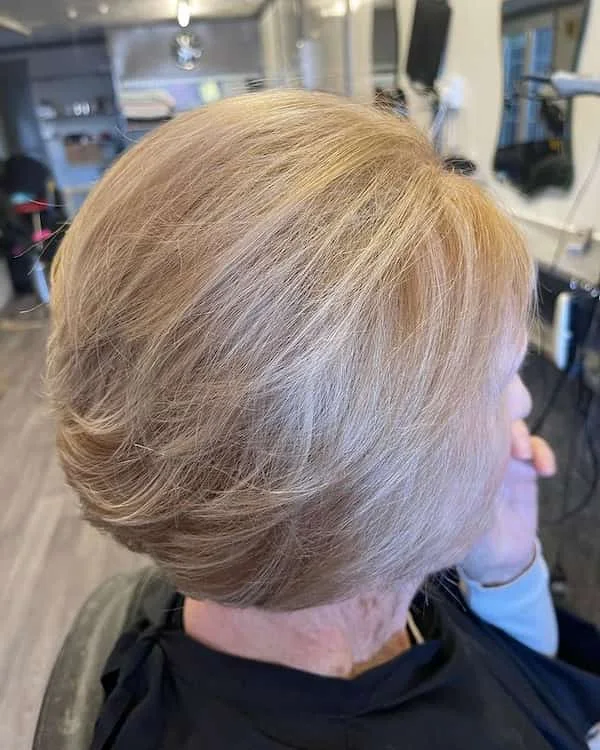 ear straight silver pixie with side swept fringe shown as a bob hairstyles for women over 60 idea